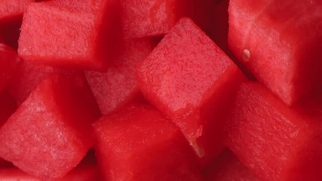 watermelon pieces, rotation in circle. juicy red watermelon without peel, Turning. selective focus. fruit and berry season. Vertical video