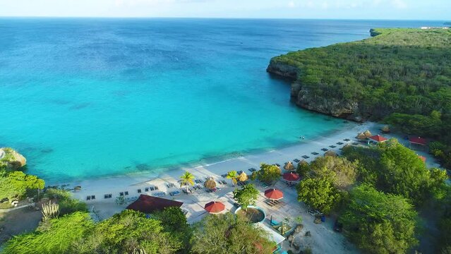 Rear view drone ascend tilt down along Grote Knip Curacao, empty serene beach