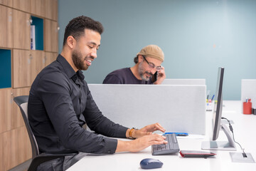 Men working using computer and talking to the mobile