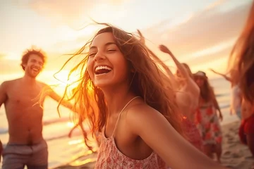  Happy friends partying on the beach. Blurred Happy friends sing and dance on the beach at a beautiful summer sunset. Young people celebrate summer. Summer holidays, lifestyle concept © arhendrix