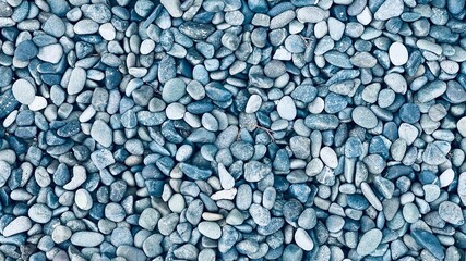 Small naturally polished green or blue rock pebbles background