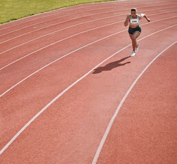 Woman, athlete and running on stadium in fitness, workout or cardio exercise for practice or...
