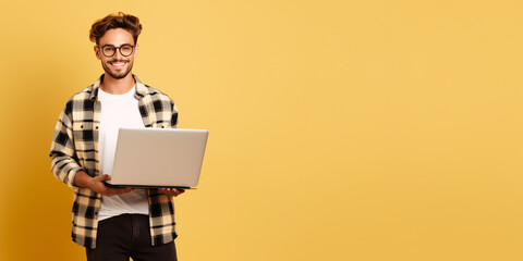 Tech-Savvy IT Professional with Laptop on Yellow Background