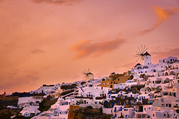 Oia village, windmills, Santorini island, Greece at colorful sunset