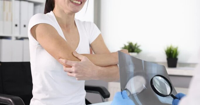 Doctor examines an x-ray of patient with elbow pain. Elbow joint pain concept