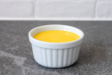 Homemade vanilla custard on gray stone background