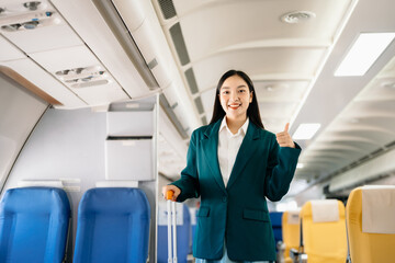 Young Asian executive excels in first class, multitasking with digital tablet, laptop and smartphone. Travel in style, work with grace. in morning light.