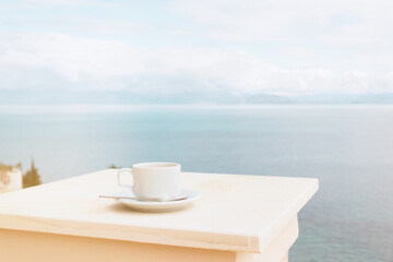 Cup of coffee on the terrace overlooking the sea. Vacation scene. Relaxed resort morning on the...