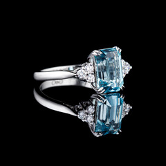 beautiful white gold ring with diamonds and aquamarine on a black background