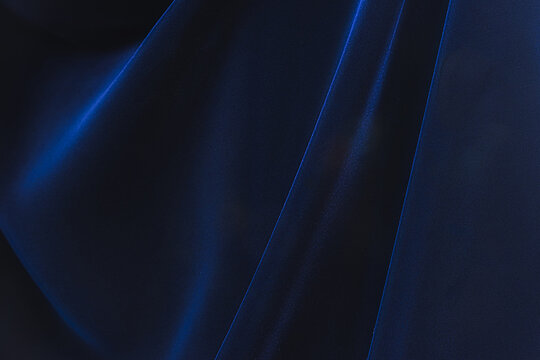 Navy blue velvet fabric. Velvet shiny dark blue fabric. Dark luxury background with space for design. Flat lay, top view table. Beautiful.Elegant.Birthday,Christmas.