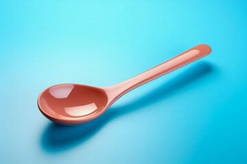 A colorful ladle isolated on a minimalist gradient blue background 