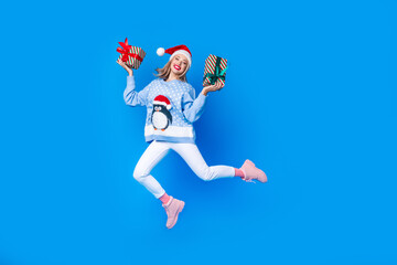 Full body cadre of jumping with two gift boxes girl invite brochure shopping mall new year atmosphere isolated on blue color background