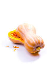 pumpkin cut in half with seeds on white background