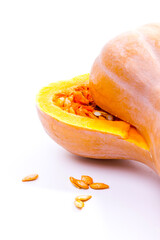 pumpkin cut in half with seeds on white background