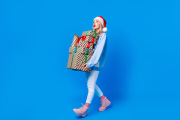 Full body photo of young girl amazed stupor looking empty space wear traditional clothes hold gifts...