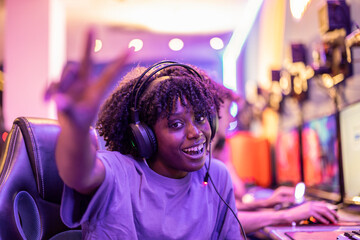 pretty smiling African woman esport game player happy in the battle game with her gaming team, in a video game competition