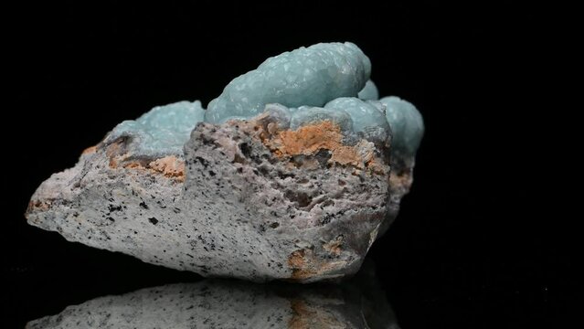 Green Hemimorphite or Calamine sample rotating slowly against a black background.