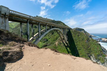 California, USA - May 19, 2018: big sur bridge with arch structure and pacific highway one on sunny day in spring