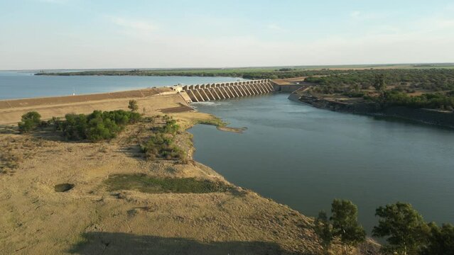 High aerial fly up Vaal River, over Bloemhof Dam wall with high water level