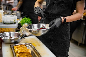 professional chef's hands cooking Raw beef meat tartar in restaurant kitchen