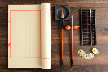 A brush ledger, abacus, and coins on a retro wooden background. The Chinese meaning in the picture...