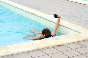 Young beautiful girl or woman in the pool, youth and attraction