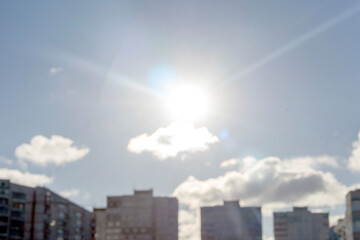 The sun over multi-storey buildings, blur