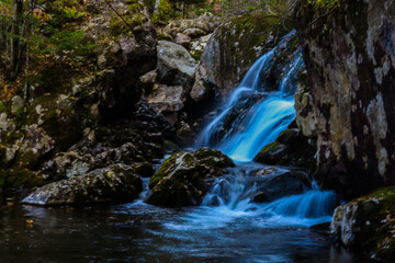 Waterfall. Tourism and travel in autumn. Holidays in the mountains.