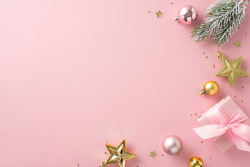 Naklejka na ściany i meble Glamorous Yuletide concept. Overhead perspective showcasing giftbox, charming tree embellishments, sparkling stars, sequins that twinkle, and frosty fir branch on pale pink backdrop for greeting text