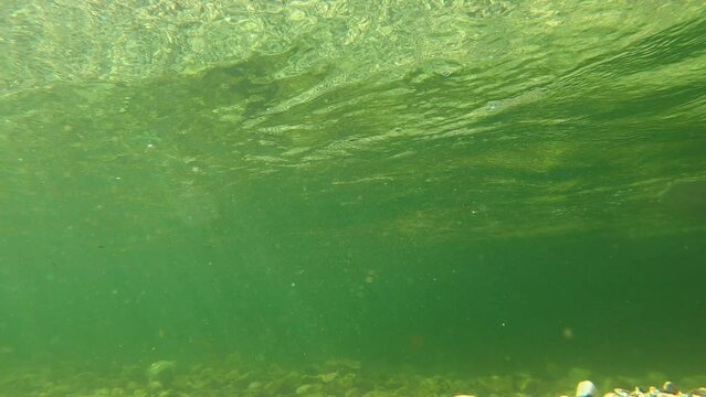 Underwater shot of canoe boat in water stream