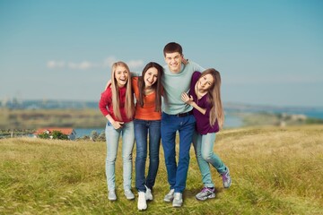 Fototapeta premium Happy young friends walk together in the countryside