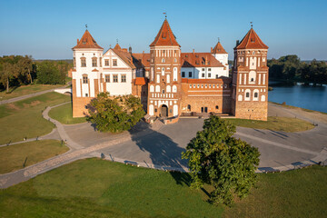 Belarus. Mir Castle Complex, a UNESCO World Heritage site in Belarus. Aerial view of a medieval castle on a bright sunny autumn day. Old architecture in colorful park view from above.