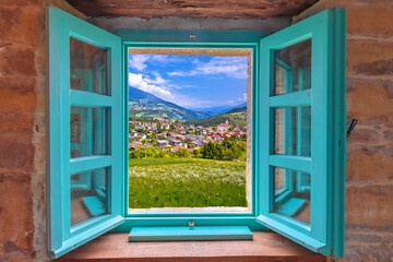 Dolomites. Idyllic alpine village of Gudon architecture and landscape view through window