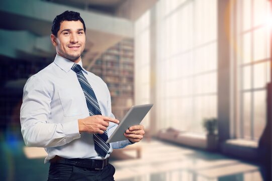 Happy business ceo standing in office with digital tablet, AI generated image