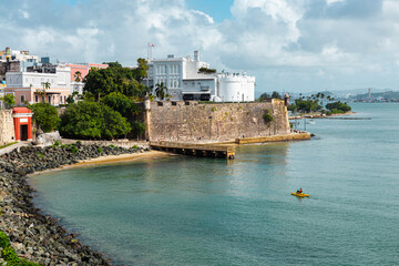 "Paseo de la princesa" side walk landscape with a wooden bridge and a water bike in el morro san juan from puerto rico