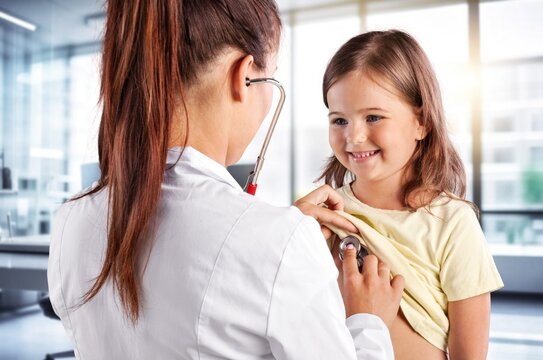 Pediatrician doctor examining cute child in clinic, AI generated image