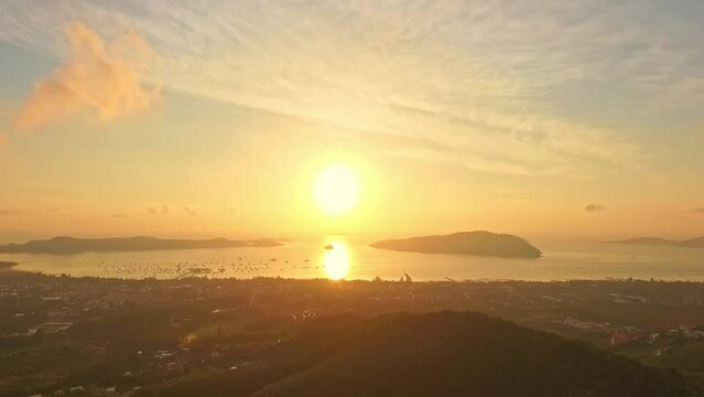 aerial view golden sun above the ocean..cloud moving above the mountain in yellow sunrise..moving cloud at yellow sunrise above the ocean..nature seascape and yellow sky of sunset over the sea.