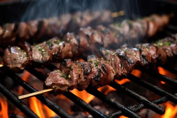 close-up shot of charred lamb kebabs on grill