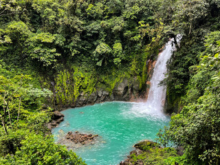Naklejka na ściany i meble Majestic waterfall in the rainforest jungle of Costa Rica. Tropical hike.