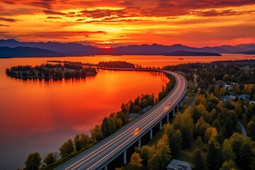 A beautiful sunset over a scenic highway and tranquil body of water