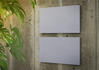 Two metal sign plates on concrete wall mockup. 