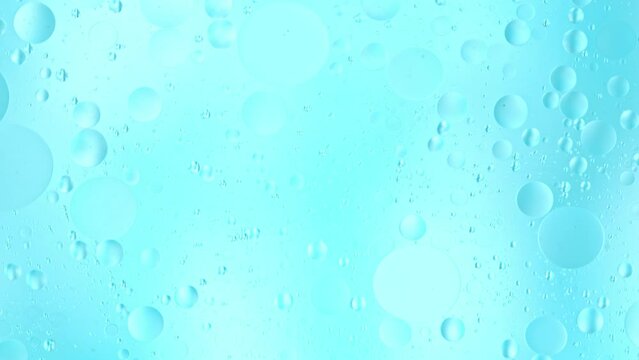 Slow Motion of Flowing Oil Bubbles in Water. Abstract Colored Background. Filmed on High Speed Cinema Camera.