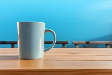 Coffee mug on wooden table, set against a serene blue backdrop