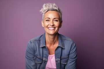 Portrait of beautiful woman smiling at camera. Isolated on purple background
