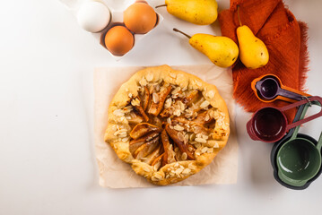 Freshly baked galette with pear on baking paper