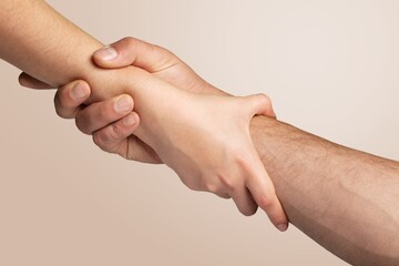 Two hands hold each other, need of help,