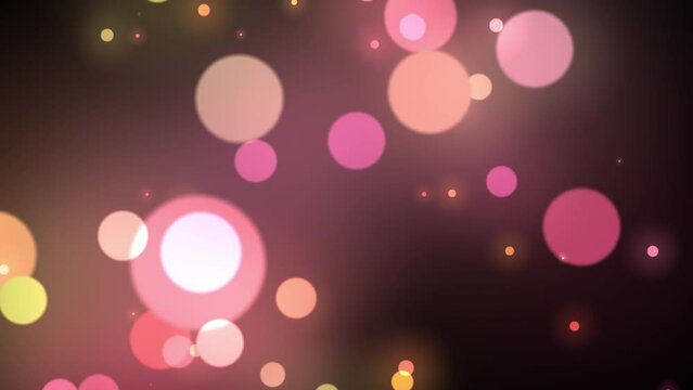 Blurred pink and yellow shimmering particles background. Bokeh colorful lights floating on dark background. 4k loop video animation.