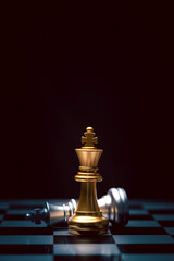 Stand of golden king chess and fallen silver king chess. Winner of business competition and...
