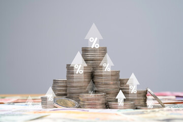 Heap of coins money with up arrow and percentage symbol for financial banking increase interest...