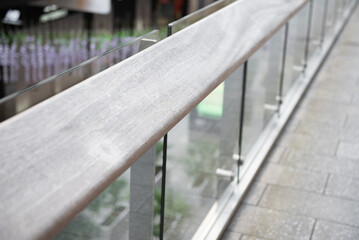 Wooden railing with tempered glass of walk way balcony.